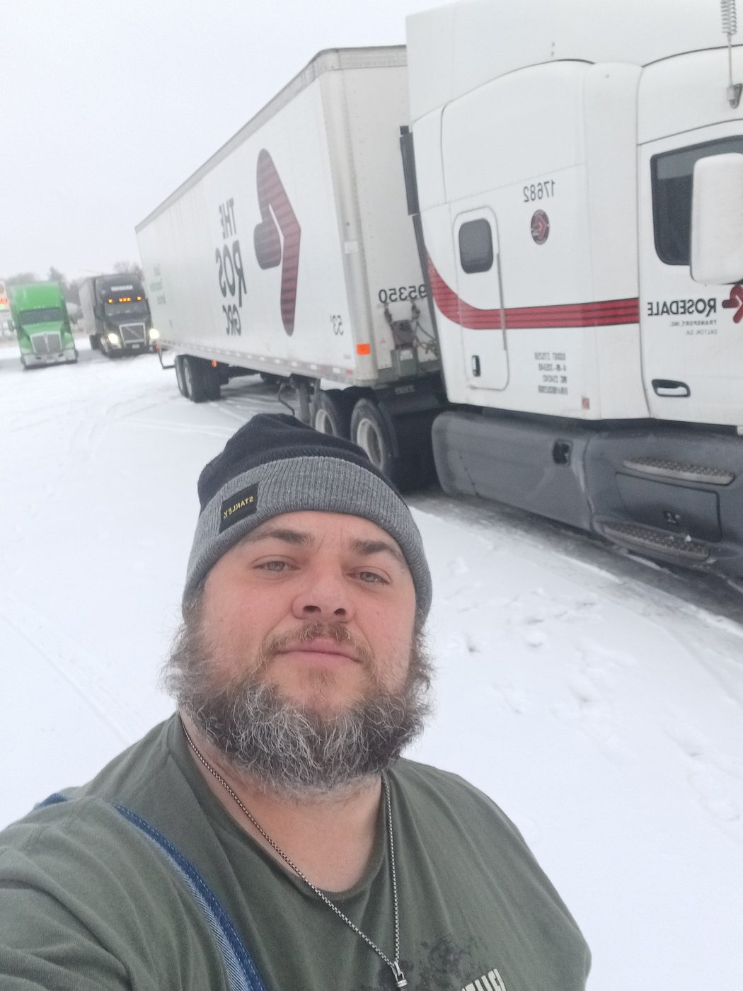 Shawn standing in front of a Rosedale Transport truck in the snow