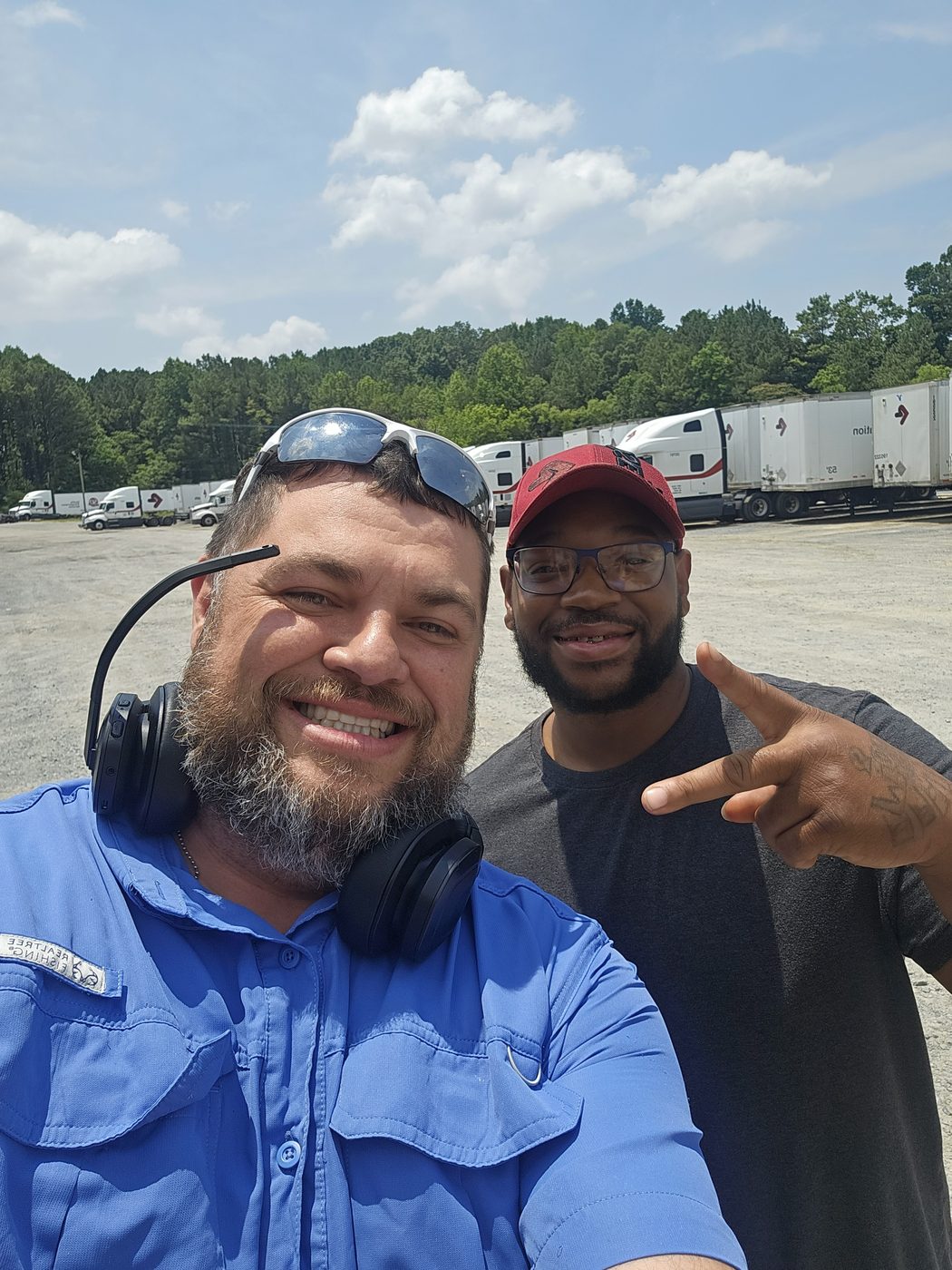 Shawn with a fellow driver at a trucking yard